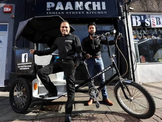 Operations manager Amirul Ali, left, and business owner Shahriar Uddin with their new rickshaw at Paanchi Indian Street Kitchen, Fratton Road. This replaces their last one which was stolen. Picture: Chris Moorhouse