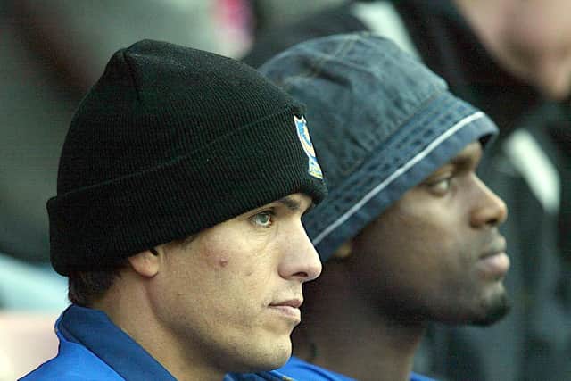 Pompey's Laurent Robert and Salif Diao sit in the stands after failing to make the match-day XI for the game against Sunderland