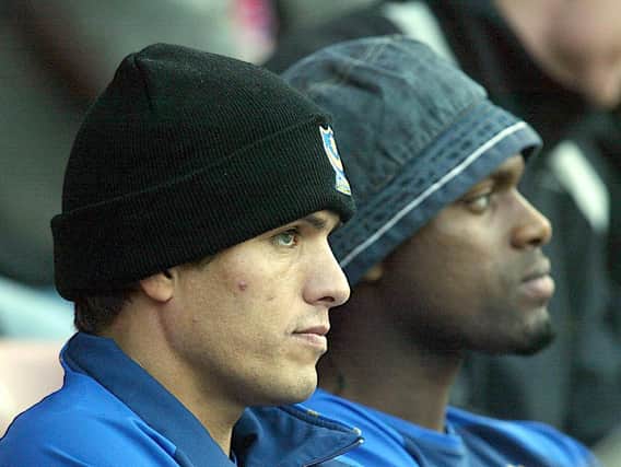 Pompey's Laurent Robert and Salif Diao sit in the stands after failing to make the match-day XI for the game against Sunderland