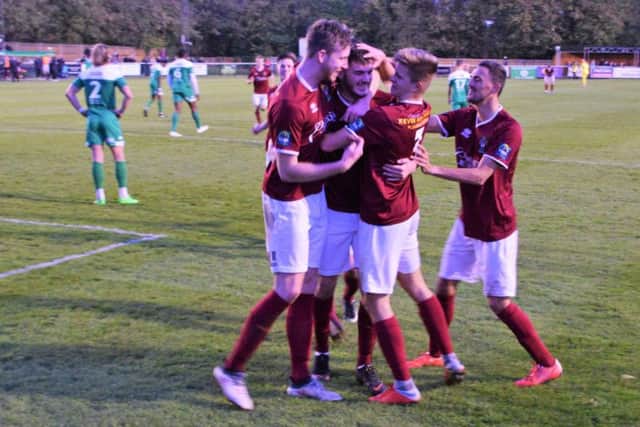 Brad Lethbridge is mobbed after his late wonder goal at Leatherhead / Picture by Darren Crisp