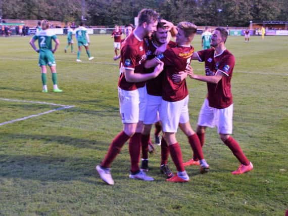 Brad Lethbridge is mobbed after his late wonder goal at Leatherhead / Picture by Darren Crisp