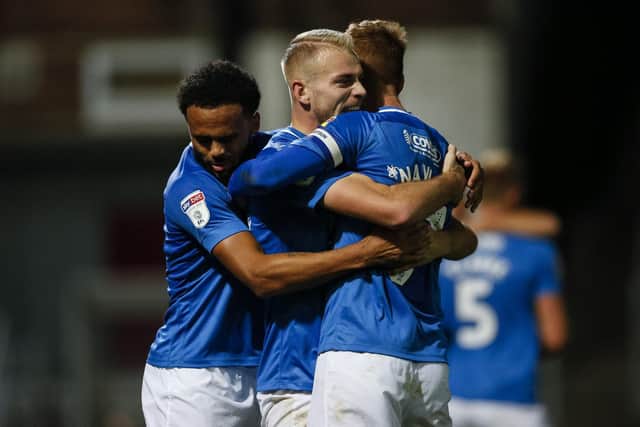 Anton Walkes, Jack Whatmough and Tom Naylor embrace at Valley Parade following a club-record 10 away matches unbeaten. Picture: Daniel Chesterton