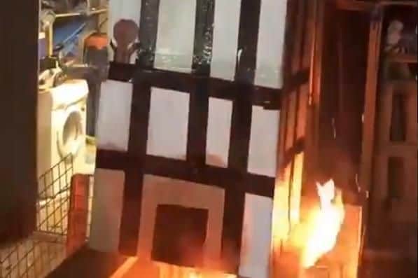Undated grab taken from a video posted on social media of a model of Grenfell Tower being burned over a fire. Picture: PA/PA Wire