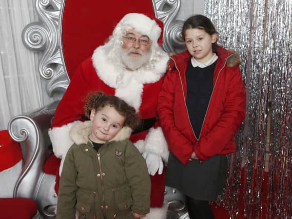 Bella, three, and her sister Lola, nine, with Santa in the Grotto in Cascades, Portsmouth.
Picture : Habibur Rahman