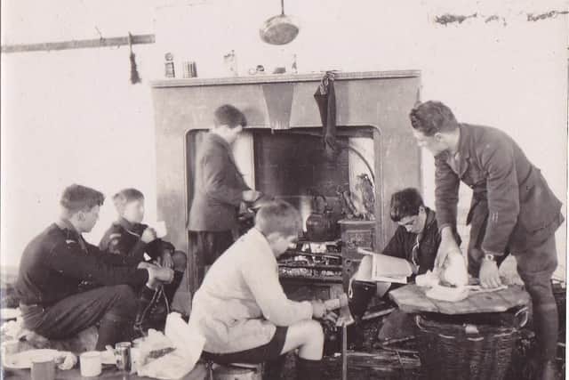 The Rev Herbert Butler Cowl teaching Boy Scouts how to cook.