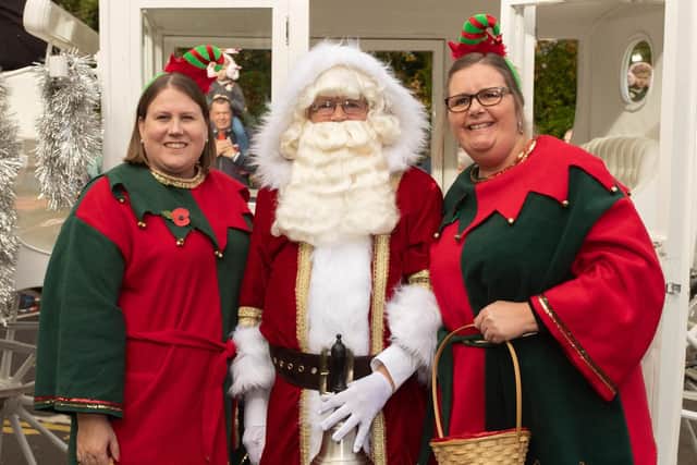 Santa with two of his helpers.Picture Credit: Keith Woodland