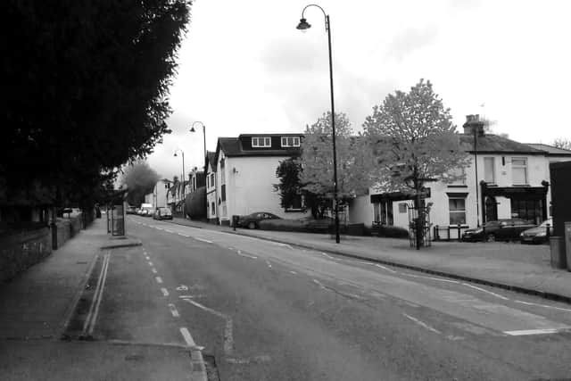 NOW: The same scene today and although the pub has long since gone the houses on the right remain.