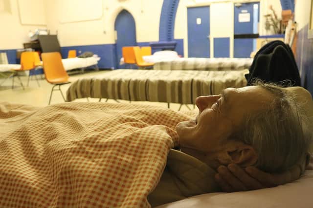 One of the guests from last winter, Waldemar, trying out a bed inside St Simons Church, Southsea