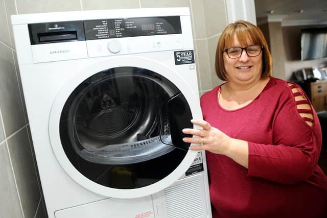 Beverley Brodie with her replacement tumble dryer.
Picture: Sarah Standing (180812-8166)