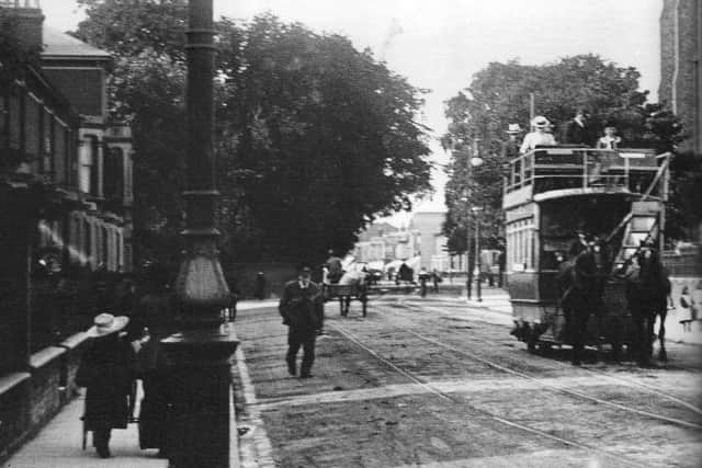 A look along Fratton Road with a horse-drawn tram at the turn of the last century. St Marys Church bell tower is on the right.