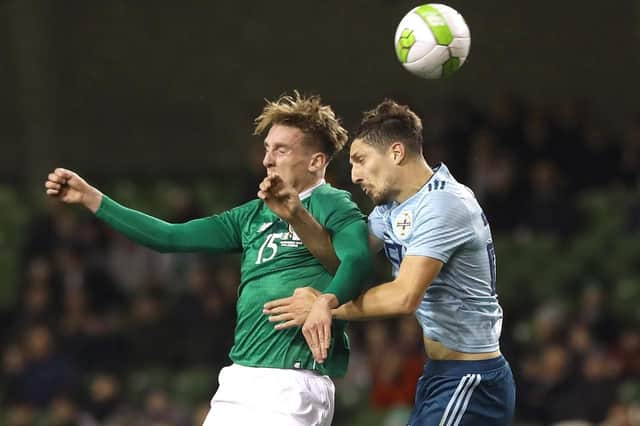 Republic of Ireland's Ronan Curtis, left, and Northern Ireland's Craig Cathcart battle for the ball during the International Friendly at The Aviva Stadium, Dublin.