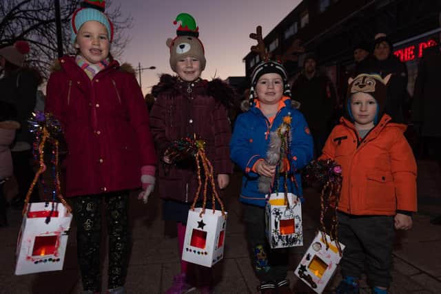 Switching on of the Christmas Lights at Waterlooville Precinct - from left, Evie Burden, seven, Alice Dickenson, six, Thomas Dickenson, four, and Luke Burden, three, all from Waterlooville with their lanterns. Picture: Vernon Nash (180685-006)