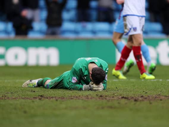 A dejected Trevor Carson after Pompey concede their fifth goal in a familiar Glanford Park defeat in February 2014. Picture: Joe Pepler