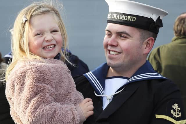 A sailor and his daughter during the homecoming of HMS Diamond.