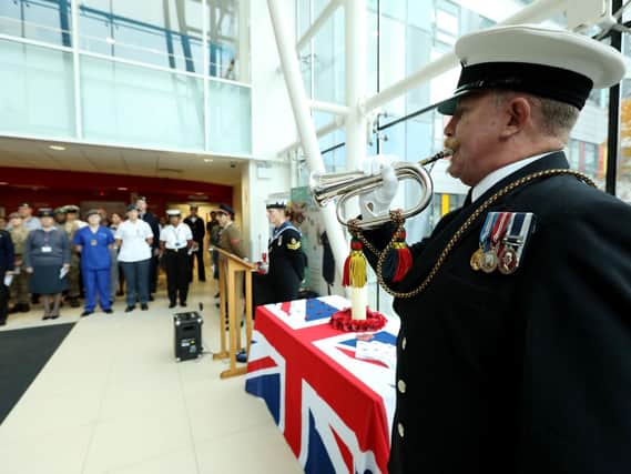 Bugler Neil Silvester of the Royal Naval Volunteers Band, HMS Nelson, plays The Last Post at the  Service of Remembrance, Queen Alexandra Hospital, Cosham