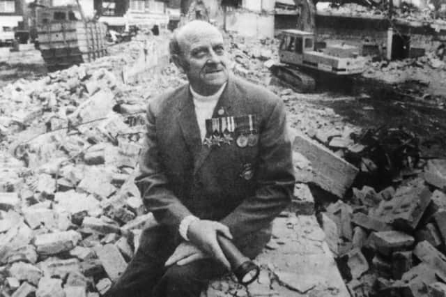 Former Southsea Odeon page boy Ronald Mears amid the rubble of the demolished building.