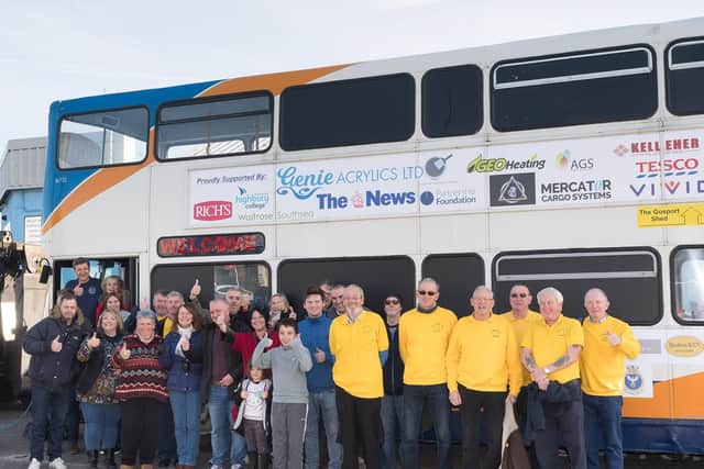 Some of the many volunteers and sponsors alongside the bus when it was launched. Picture: Keith Woodland