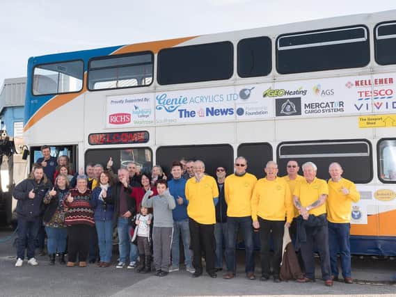 Some of the many volunteers and sponsors alongside the bus when it was launched. Picture: Keith Woodland
