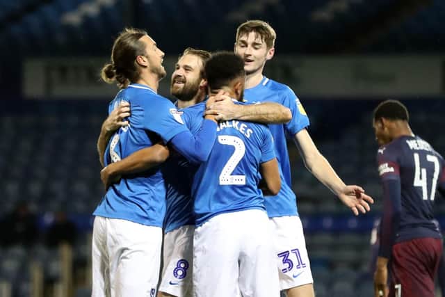 Brett Pitman, centre, celebrates his 10th-minute opener with his team-mates Picture: Sean Ryan