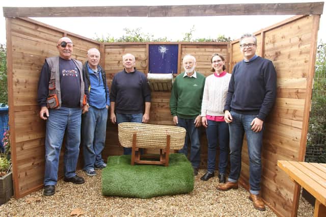 The Rev Ian Snares, vicar, St Wilfrids, Cowplain (far right), the Rev Julie Minter, curate, St Wilfrids Church, with members of the Mens Shed team who built the nativity scene