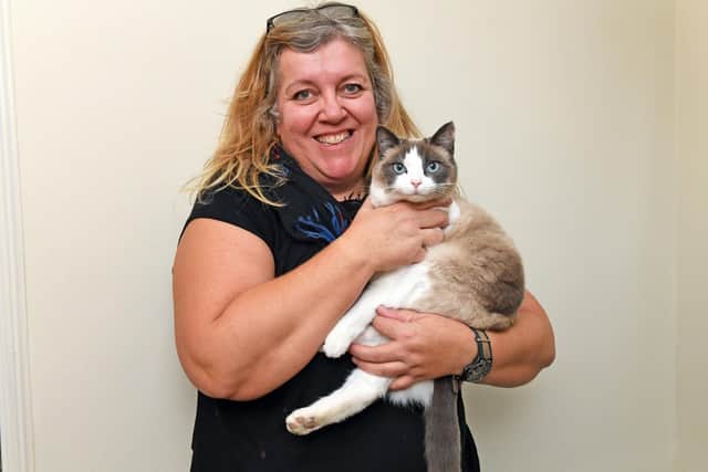 Veterinary nurse Beverley Elmer at her Southsea home with one of her cats, Stormzee
Picture: Malcolm Wells (181212-0824)