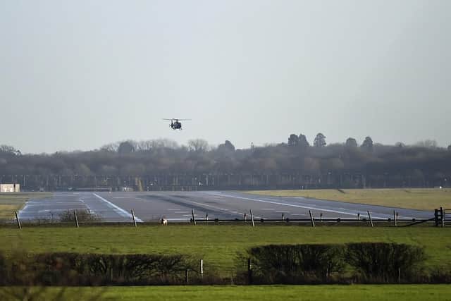A helicopter flies over the runway at Gatwick airport. Picture: Pete Summers/PA Wire