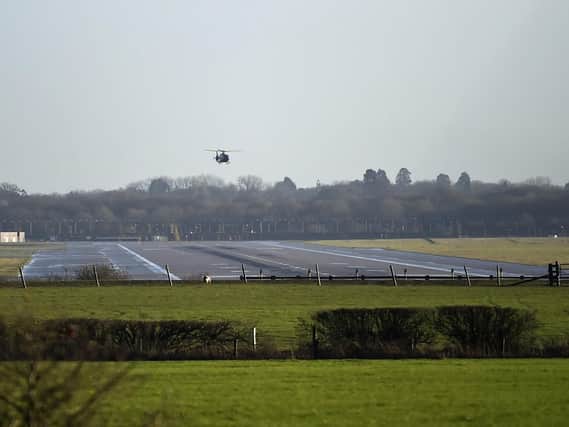 A helicopter flies over the runway at Gatwick airport. Picture: Pete Summers/PA Wire