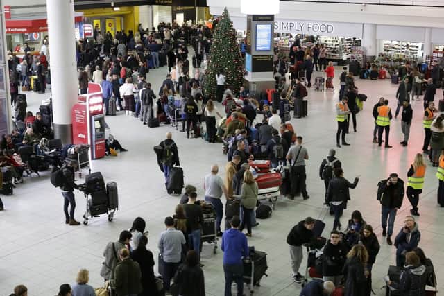 People queue at Gatwick as the airport remains closed with incoming flights delayed or diverted to other airports. Picture: PA