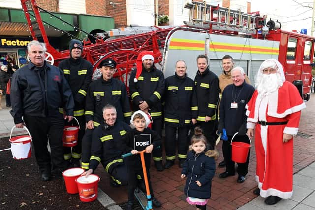 Portchester firefighters were joined by two local children and Father Christmas as they surrounded a vintage Dennis pump escape. Picture: Malcolm Wells (181221-1231)