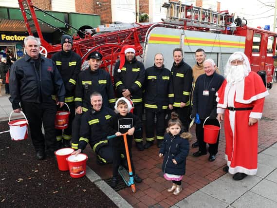 Portchester firefighters were joined by two local children and Father Christmas as they surrounded a vintage Dennis pump escape. Picture: Malcolm Wells (181221-1231)
