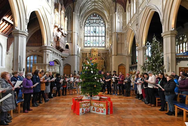 The 'Comfort and Joy' Christmas voucher campaign supported by The News concluded on Friday with a special festival carol service at St Mary's Church, Fratton, in Portsmouth, Hampshire led by Father Bob White when thousands of pounds worth of donations were distributed to each of the deserving charities. Representatives from each good cause were at the event, and enjoyed a good sing-song as they joined in with the carols. Picture by Malcolm Wells