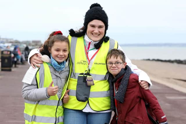 Volunteers Elizabeth Llewellyn with Tanisha Gray, 11, and Pearson Atkinson, 10. Picture: Chris Moorhouse