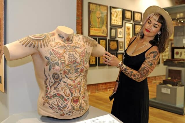 Derryth Ridges at the British Tattoo Art Revealed exhibition at the National Museum of the Royal Navy, in Portsmouth