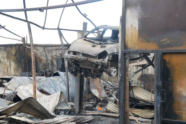 Damage left to the car workshop, including a Ford RS2000. Picture: Habibur Rahman