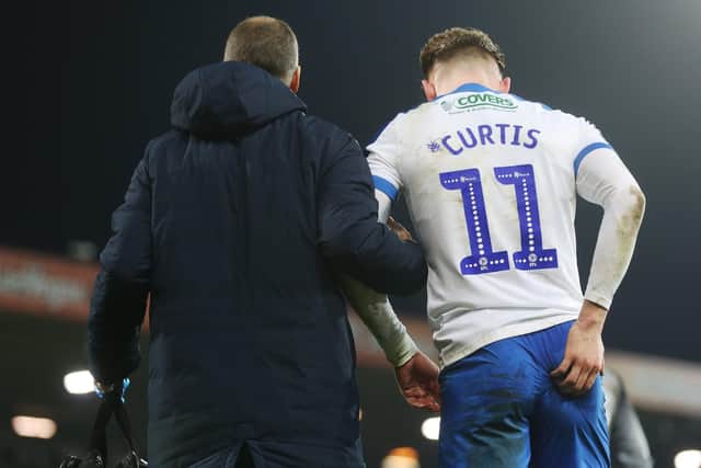 Ronan Curtis is assisted off the pitch at Carrow road by Pompey physio Bobby Bacic Picture: Joe Pepler