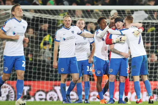 The Pompey players celebrate their third-round victory against Norwich at Carrow Road Picture: Joe Pepler