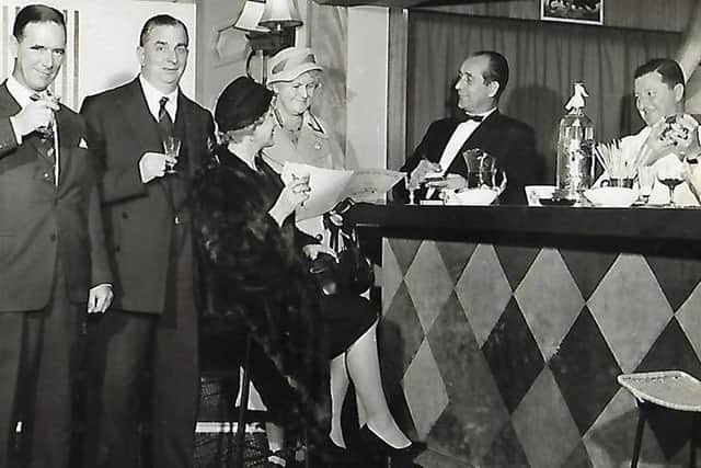 Henry behind the bar taking orders in the Belshazzar Restaurant in the 1950s.
