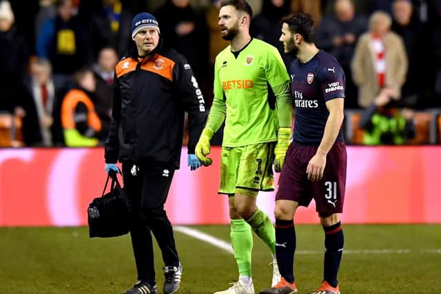 Mark Howard limps off against Arsenal. Picture: Anthony Devlin/ PA Images