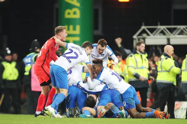 Andre Green and his Pompey team-mates celebrate - a moment captured by Andy Moon's commentary. Picture: Joe Pepler