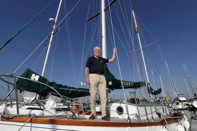 Sir Robin Knox-Johnston stands on the deck of his boat Suhaili on which he became the first person to sail non stop around the world 50 years ago. Picture: Andrew Matthews/PA Wire
