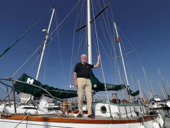 Sir Robin Knox-Johnston stands on the deck of his boat Suhaili on which he became the first person to sail non stop around the world 50 years ago. Picture: Andrew Matthews/PA Wire