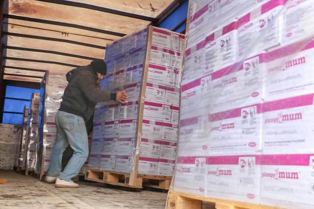 A shipment of the food packets, donated by Need Street Food, being loaded up