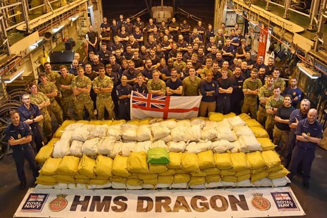 HMS Dragon's ship's company pose with the haul of drugs they seized towards the end of last year. Photo: Royal Navy