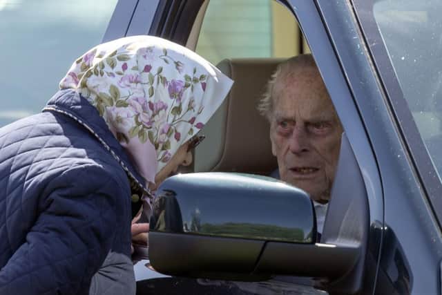 The Duke of Edinburgh, 97,  who was left 'very shocked' and shaken when the Land Rover Discovery he was driving was hit by a Kia as he drove near the Queen's Sandringham estate on Thursday afternoon. File photo oh him talking to the Queen while at the wheel of a similar vehicle during the Royal Windsor Horse Show. Photo: Steve Parsons/PA Wire