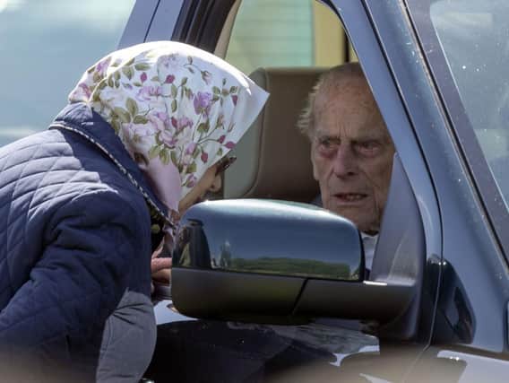 The Duke of Edinburgh, 97,  who was left 'very shocked' and shaken when the Land Rover Discovery he was driving was hit by a Kia as he drove near the Queen's Sandringham estate on Thursday afternoon. File photo oh him talking to the Queen while at the wheel of a similar vehicle during the Royal Windsor Horse Show. Photo: Steve Parsons/PA Wire