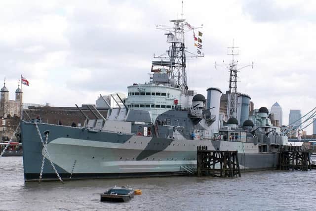 The cruiser HMS Belfast, which bombarded the beaches on D-Day, wearing Dazzle paint at her moorings on the River Thames.