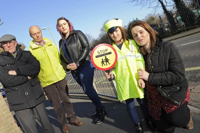 Kirsty Smillie who is the deputy head at Brune Park Community Schools Enterprise Academy protests with supporters following a decision to scrap the school lollipop man in Military Road, Gosport.(l to r), Councillor Keith Farr, Mark Smith, Emma Smith, and Emmas daughter Isabella Smith (six).Picture: Ian Hargreaves  (200119-1)