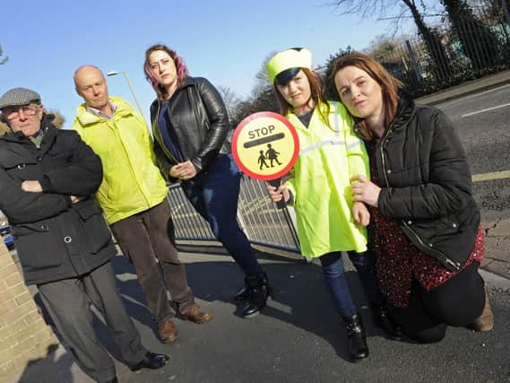Kirsty Smillie who is the deputy head at Brune Park Community Schools Enterprise Academy protests with supporters following a decision to scrap the school lollipop man in Military Road, Gosport.
(l to r), Councillor Keith Farr, Mark Smith, Emma Smith, and Emmas daughter Isabella Smith (six).

Picture: Ian Hargreaves  (200119-1)