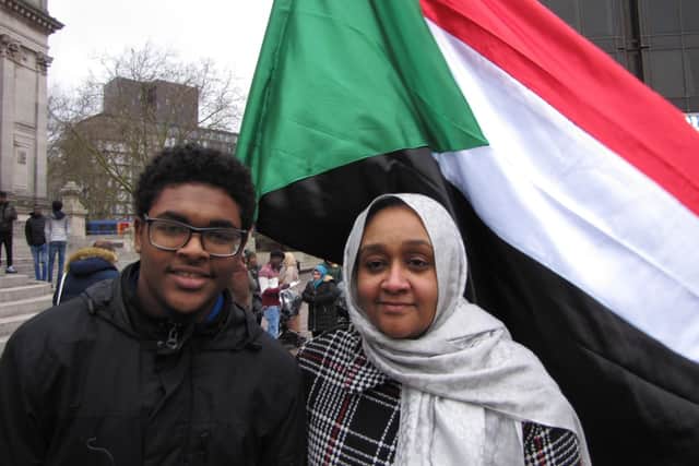 One of the organisers of the protest against the dictator in Sudan at Guildhall Square in Portsmouth, Ihsan Eltom, pictured with her son Hadi. Picture: Jon Woods