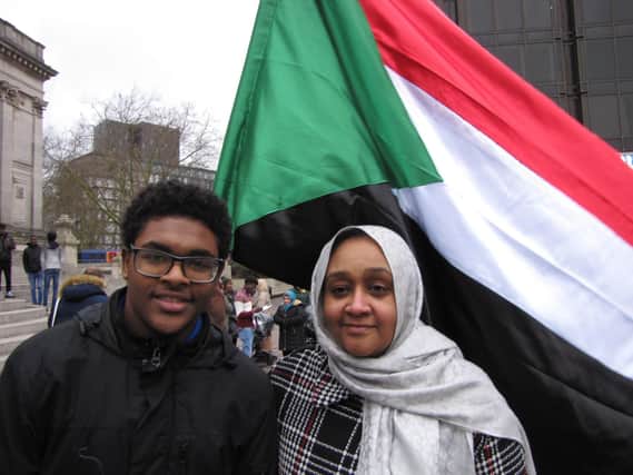 One of the organisers of the protest against the dictator in Sudan at Guildhall Square in Portsmouth, Ihsan Eltom, pictured with her son Hadi. Picture: Jon Woods